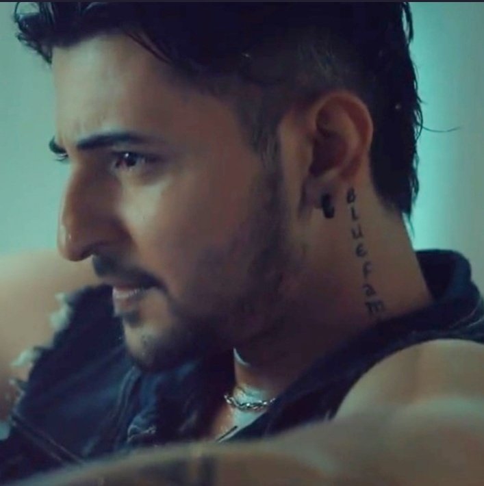 Darshan Raval tattoos: Genuine close profile photograph showing the vertical Blue Family neck lettering.