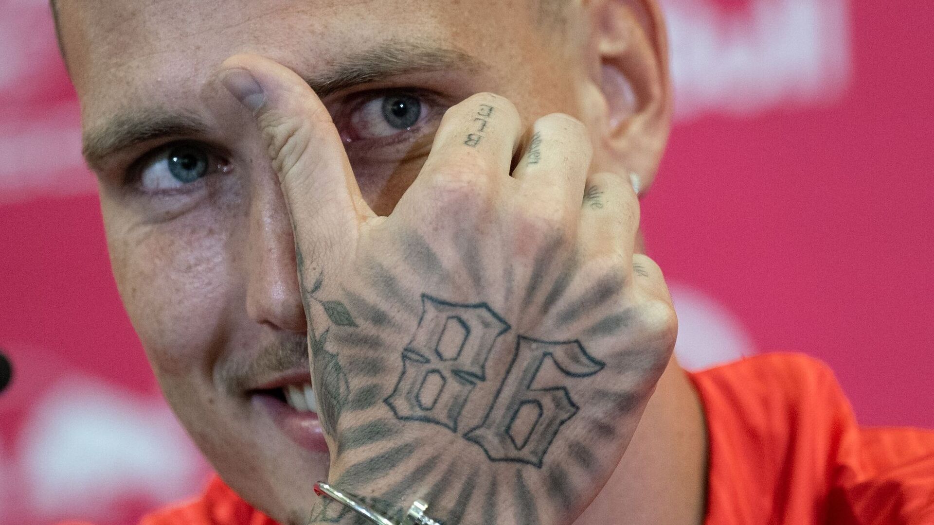 David Raum tattoos: Bold 86 hand tattoo with smaller finger lettering