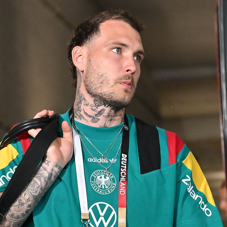 David Raum tattoos: Germany portrait showing layered forearm and neck tattoos