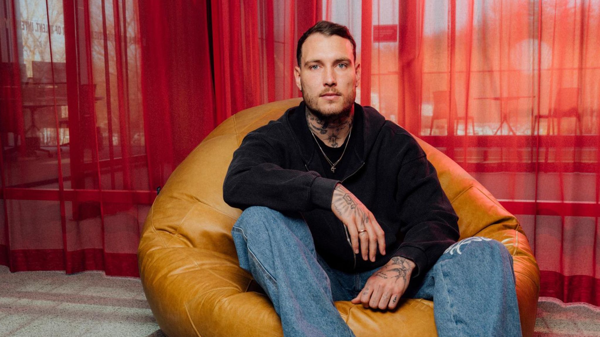 David Raum tattoos: Face-visible portrait showing neck and forearm tattoo coverage