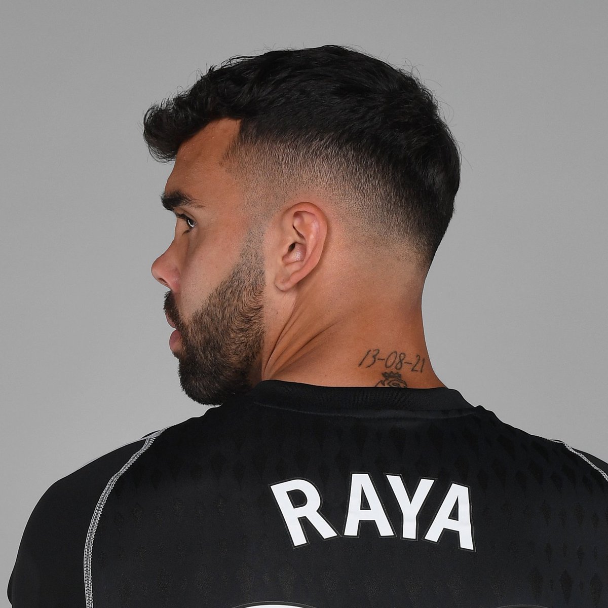 David Raya tattoos: close profile view isolating the 13-08-21 date tattoo above the shirt collar