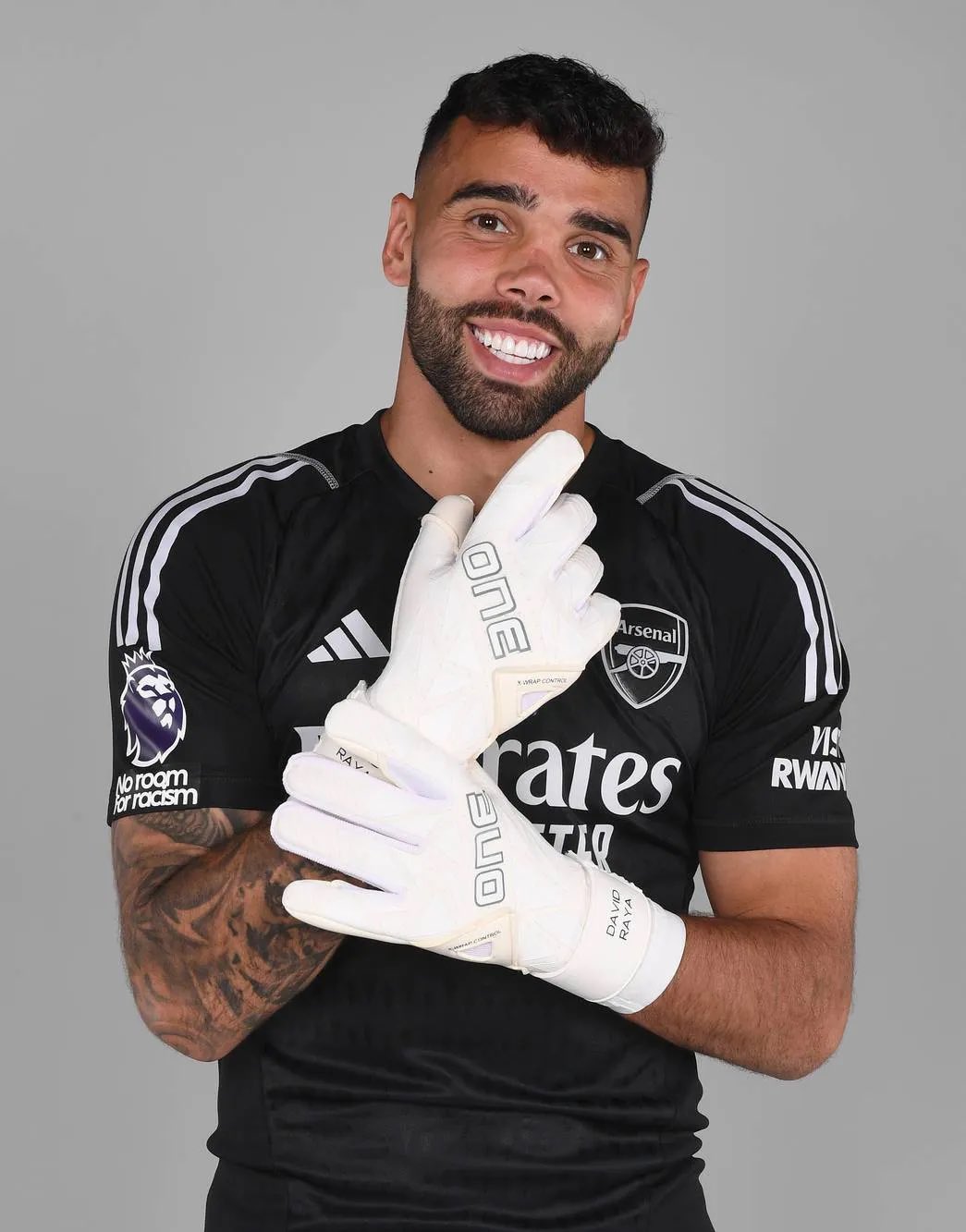 David Raya tattoos: kit-reveal portrait showing the forearm tattoo collection from a second public angle