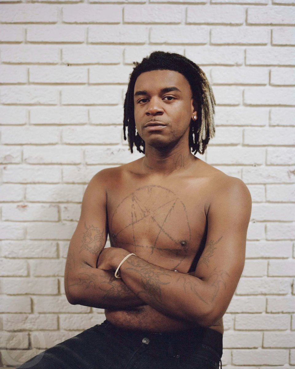 Destroy Lonely tattoos: high-resolution shirtless portrait showing the chest pentagram and arm tattoos