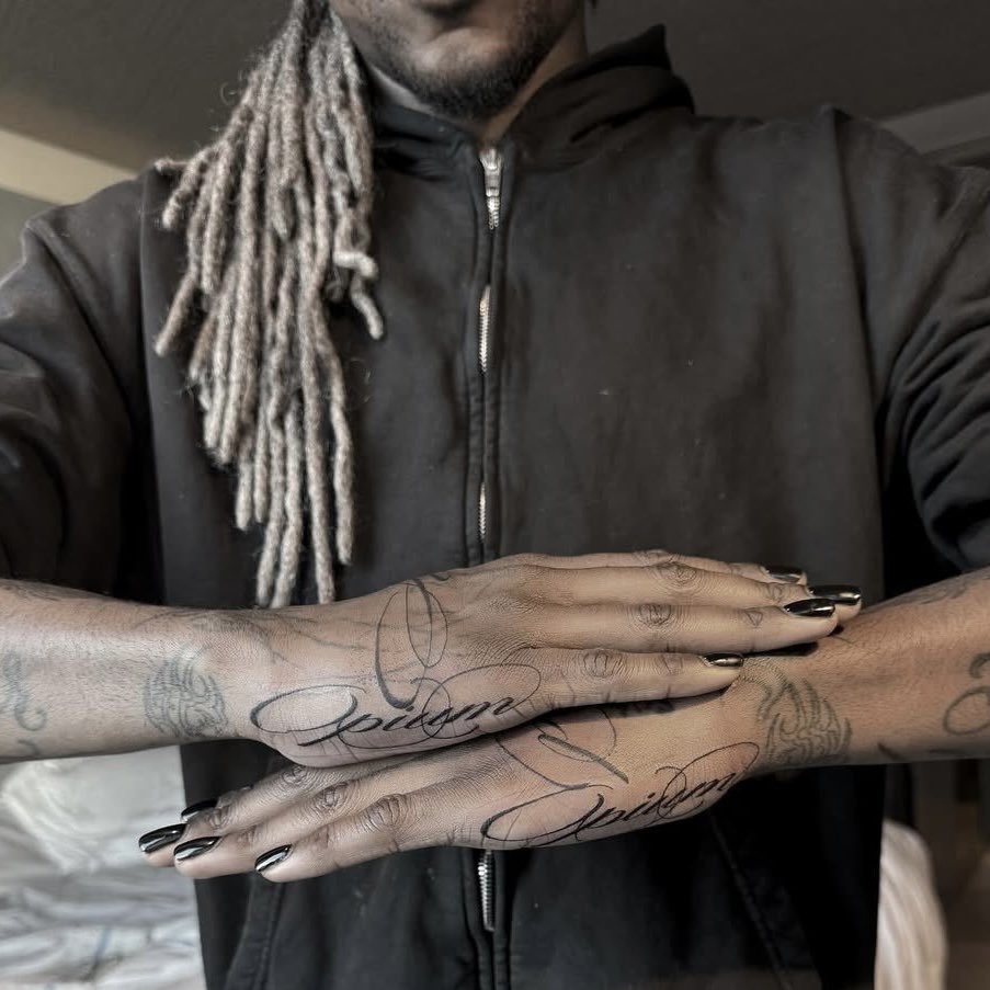 Destroy Lonely tattoos: high-resolution close-up showing the script tattoos across both hands