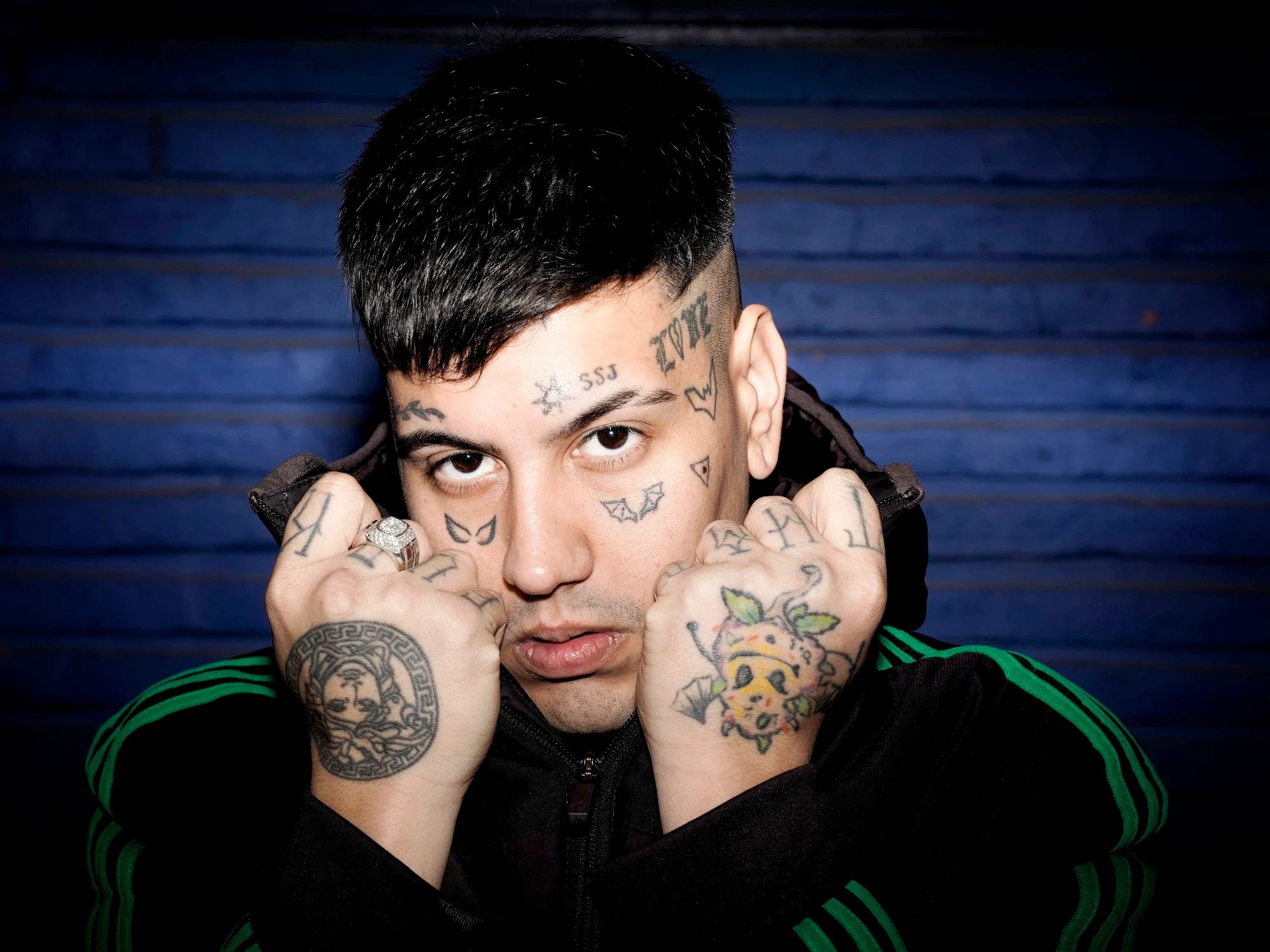 Duki tattoos: Separate portrait showing face symbols and two hand designs