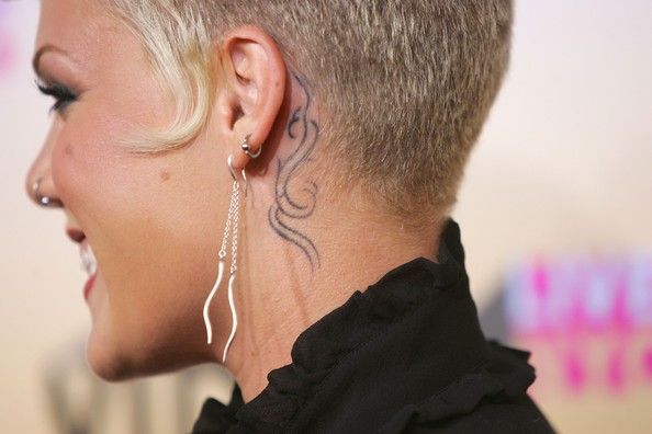 Pink behind ear tattoo