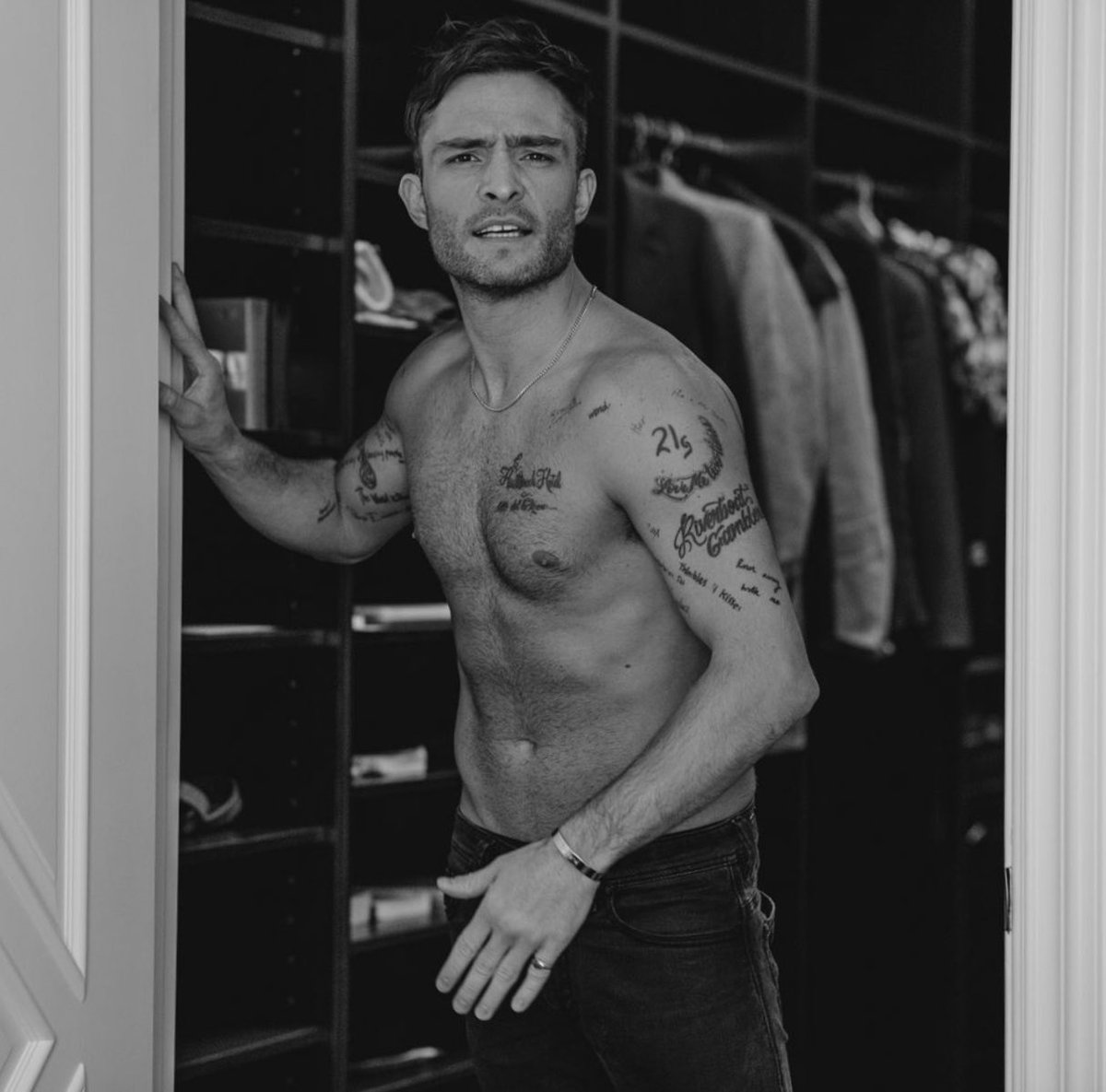 Ed Westwick tattoos: shoulder lettering and upper-arm tattoos