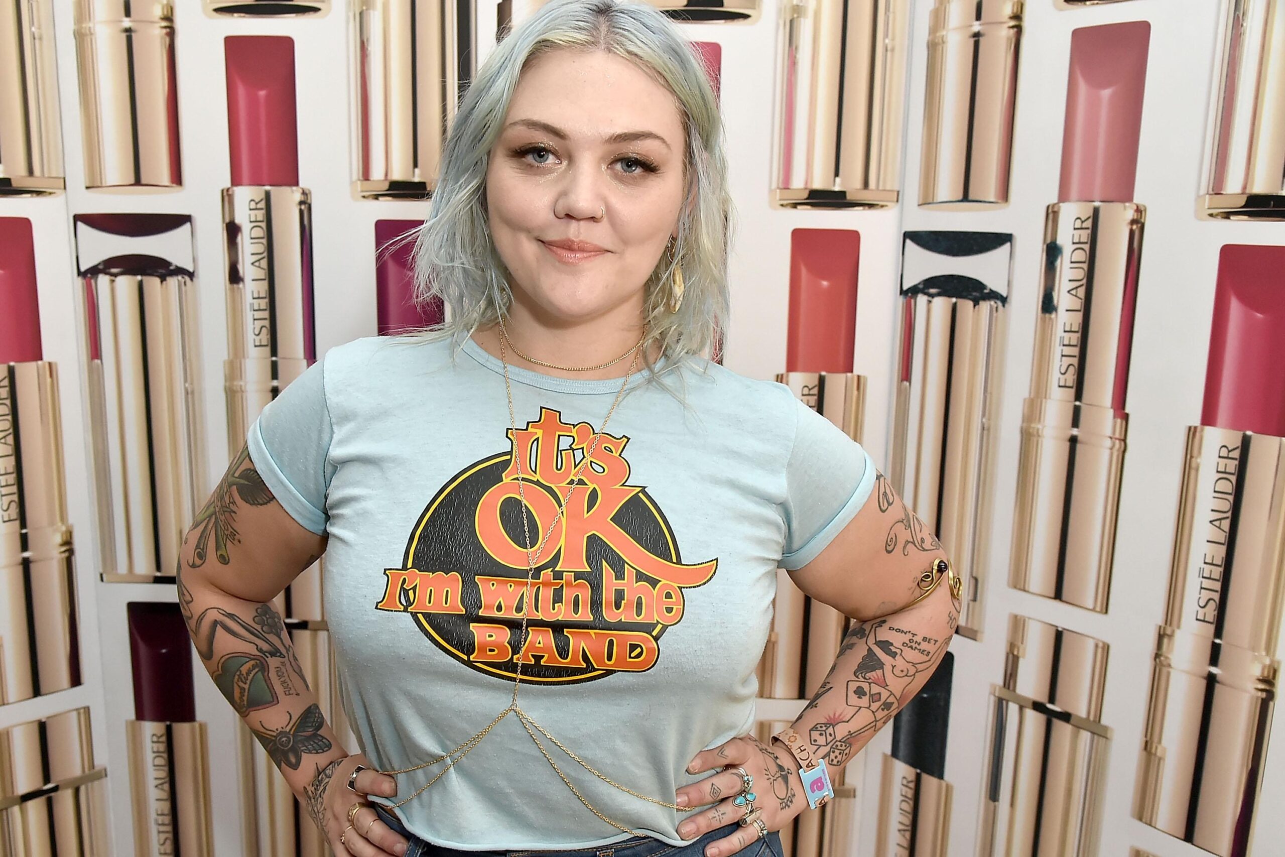Elle King tattoos: Event portrait showing both tattooed arms and hand collection