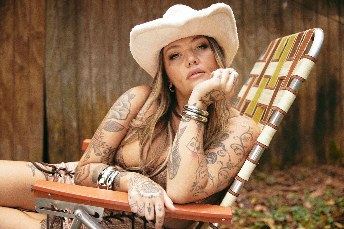 Elle King tattoos: Portrait showing Elle King's tattooed arms and hands