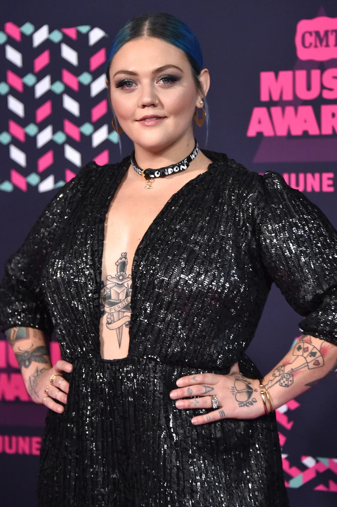 Elle King tattoos: Red-carpet photograph clearly showing the knife-through-heart chest tattoo