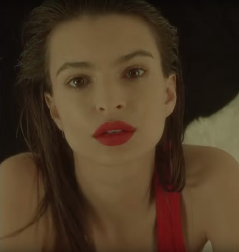 Emily Ratajkowski in a contextual photograph: Contextual portrait only; not tattoo evidence. Used to show how small ink sits inside a polished look.; not tattoo evidence