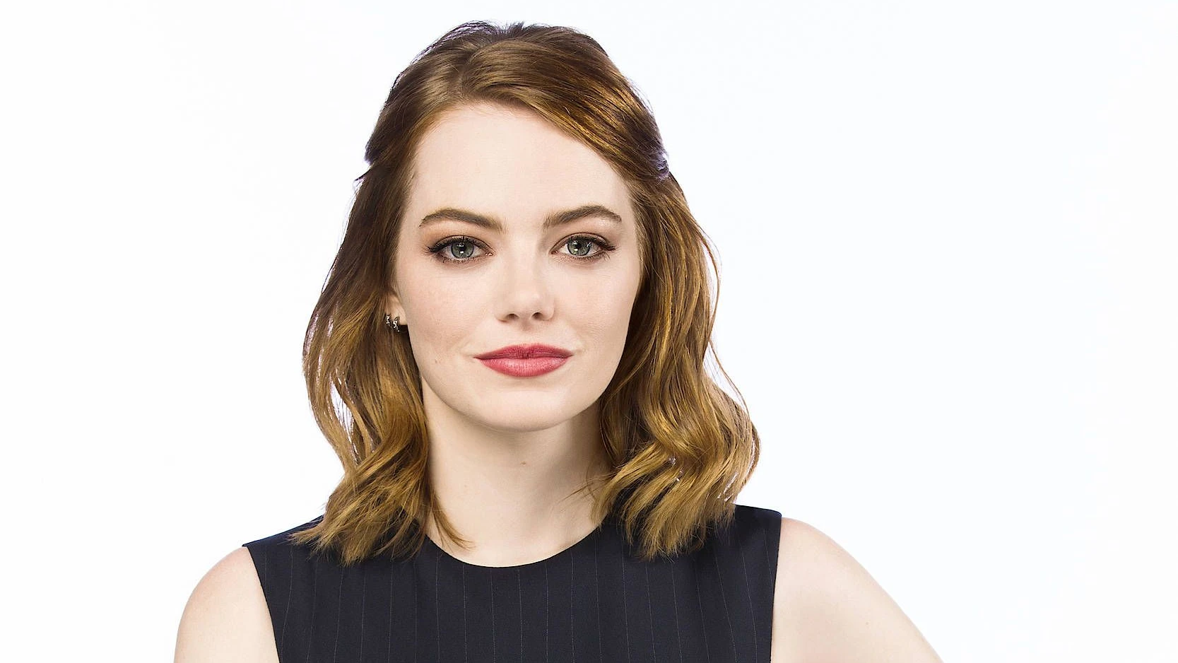 Emma Stone in a contextual photograph: Contextual portrait; not tattoo evidence.; not tattoo evidence