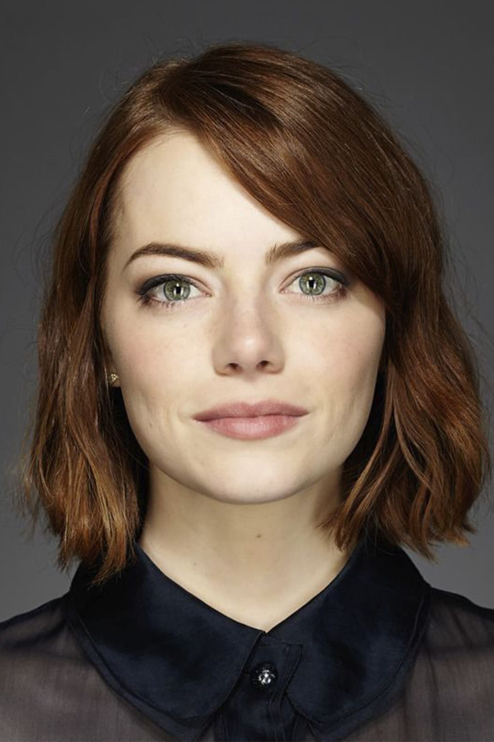 Emma Stone in a contextual photograph: Contextual portrait; not tattoo evidence.; not tattoo evidence