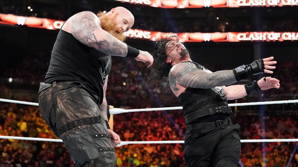 Erick Rowan tattoos: Right forearm branching outlines, shading and bold crossing shape
