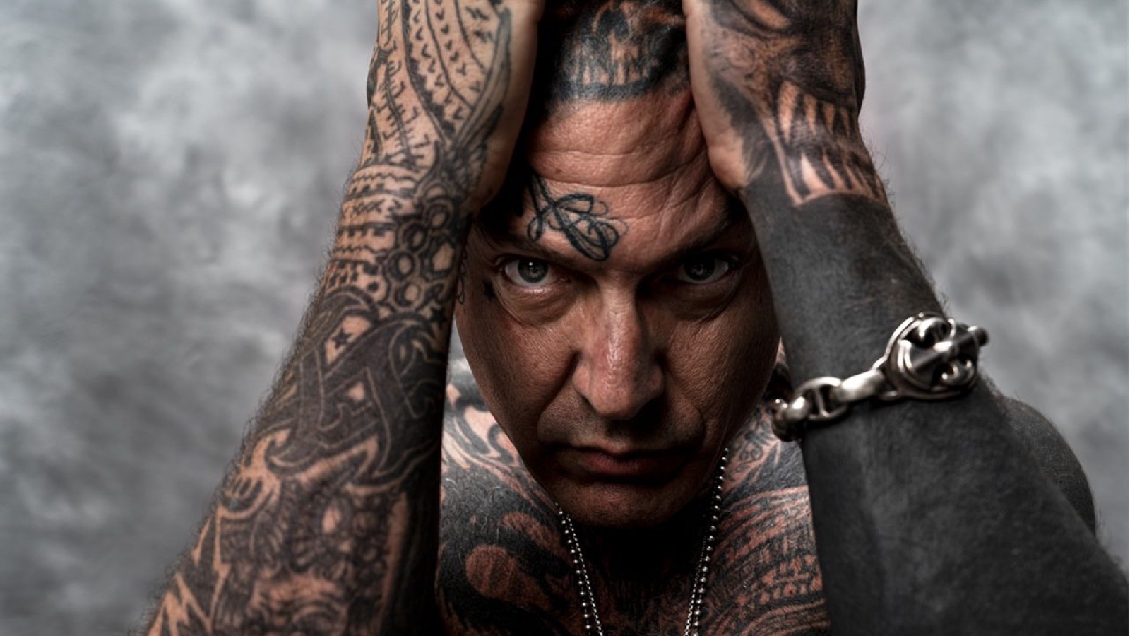 Evan Seinfeld chest, neck and arm tattoos