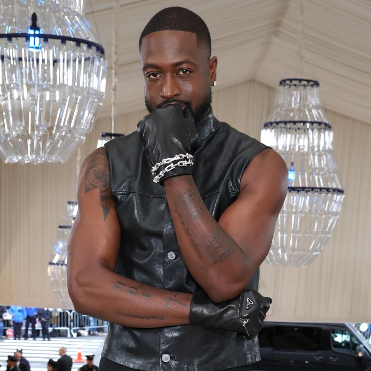 Dwyane Wade tattoos: arm and forearm tattoos visible with Wade face in a formal portrait