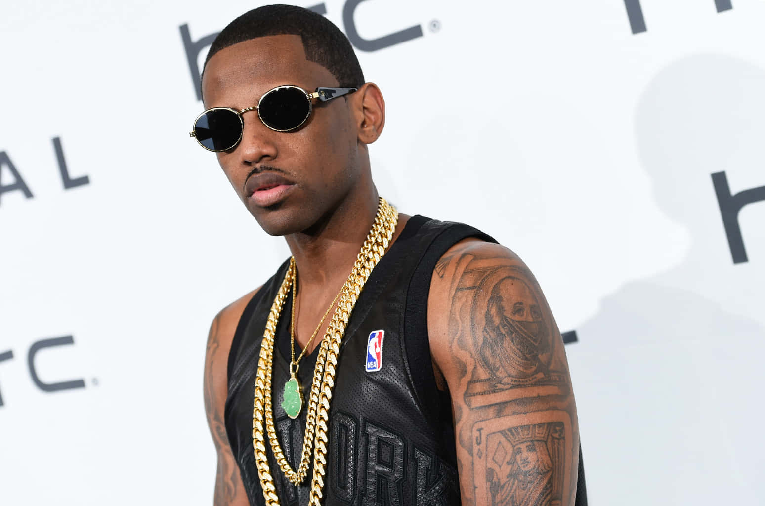 Fabolous tattoos: clear event portrait showing the large upper-arm portrait and surrounding ink