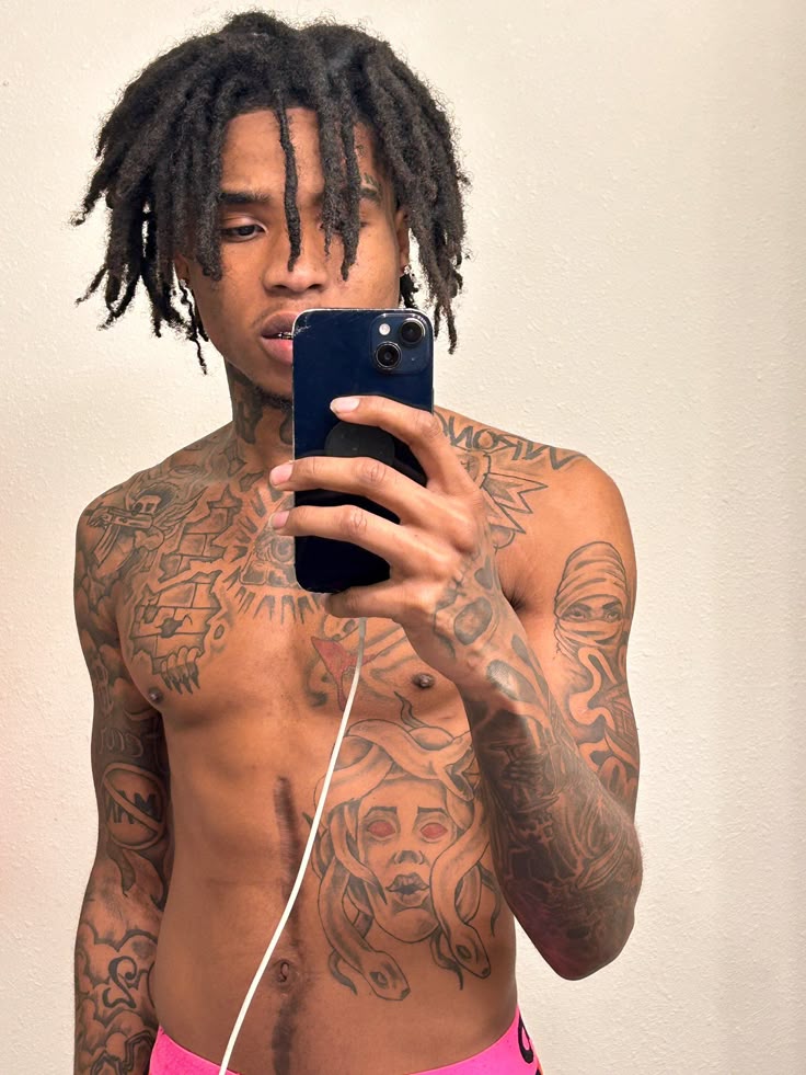Famous Dex tattoos: high-resolution mirror portrait showing the tattooed chest, stomach and arms