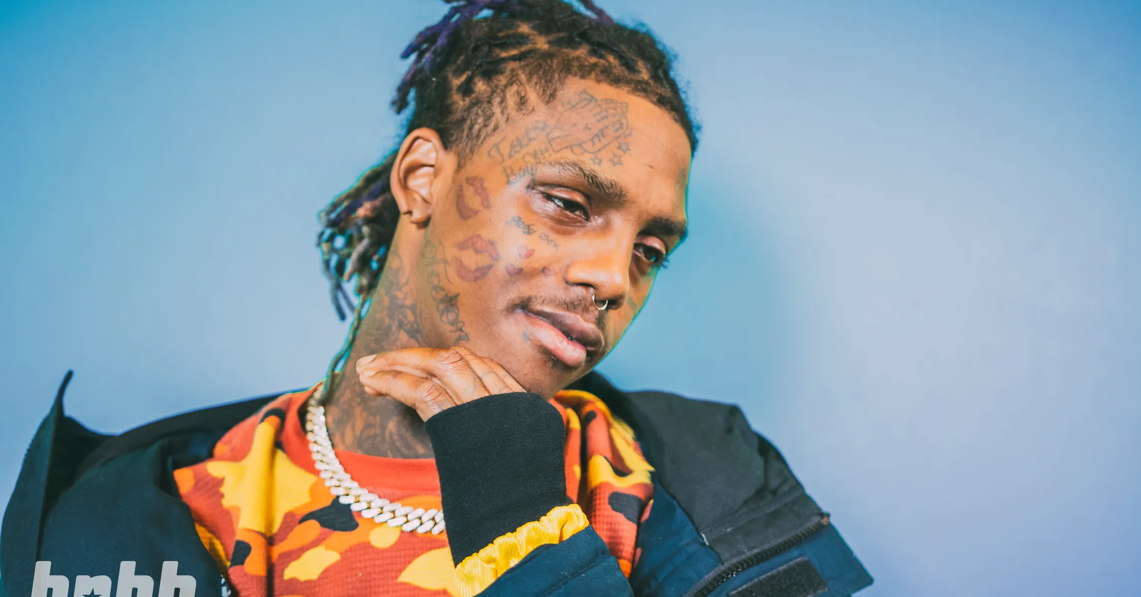 Famous Dex tattoos: high-resolution color portrait showing forehead, cheek and neck tattoos