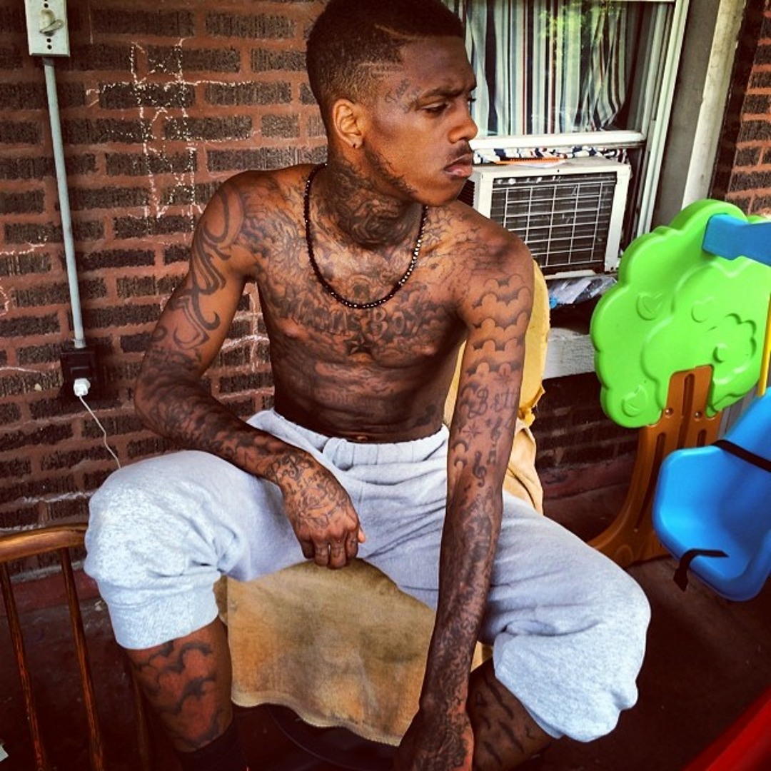 Famous Dex tattoos: high-resolution seated portrait showing chest, neck, face and both tattooed arms