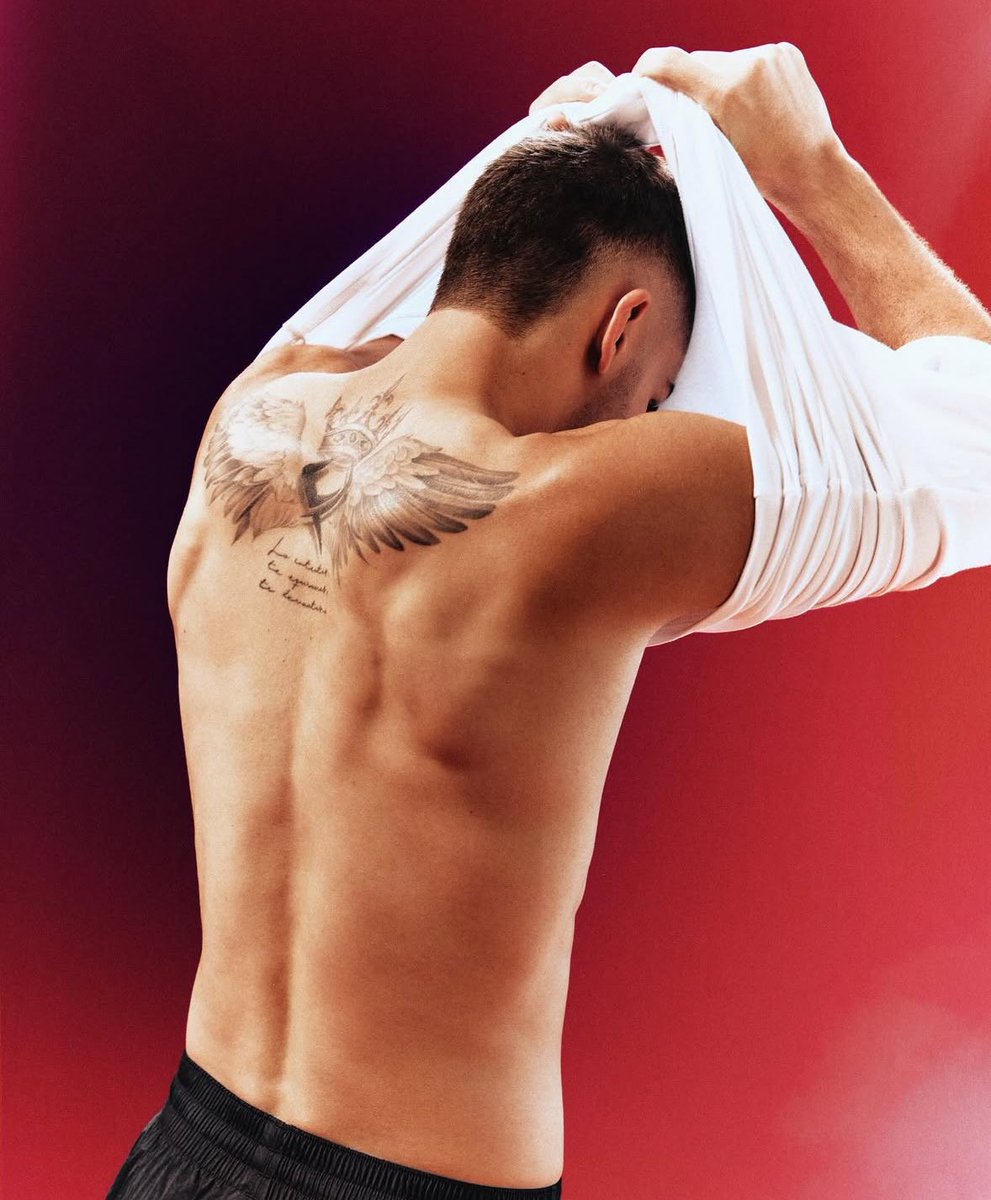Ferran Torres tattoos: A distinct standing rear photograph showing the same large phoenix-and-FT back piece from another angle
