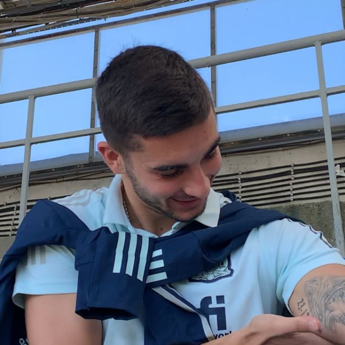 Ferran Torres tattoos: Ferran looking toward the wolf portrait and date tattoo on his upper arm, both visible in the photograph