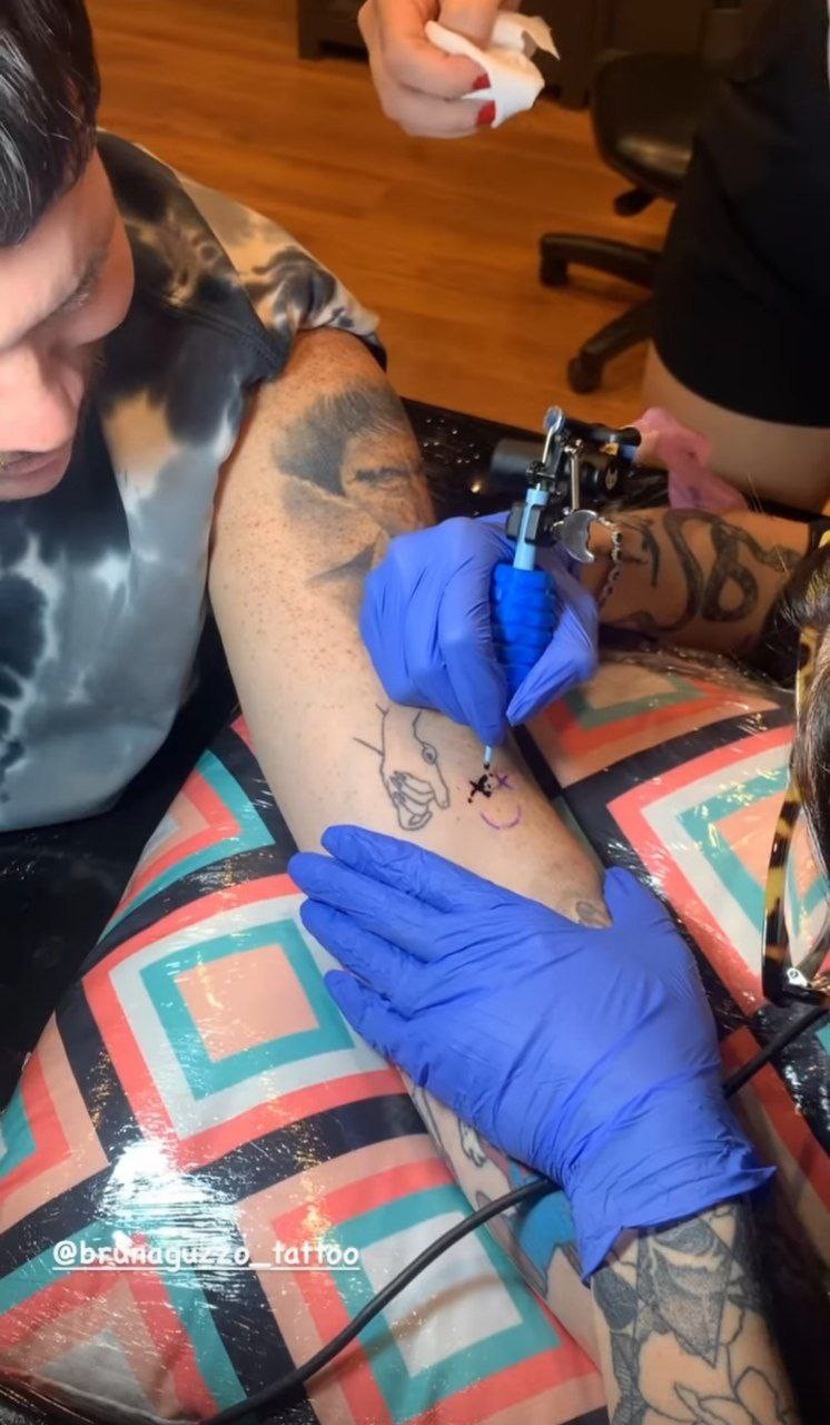 Ferrugem tattoos: Distinct genuine tattoo-session photograph from the documented Quem report.