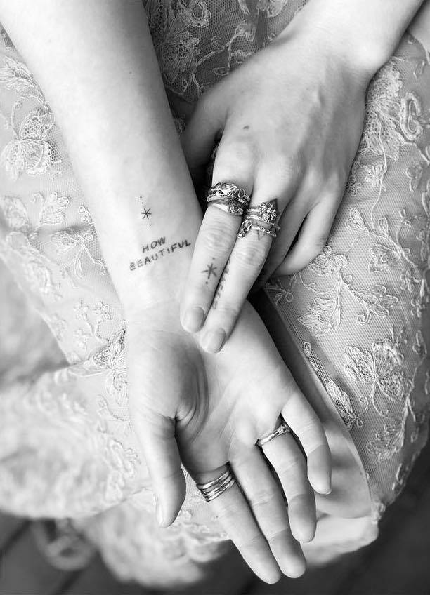Florence Welch wrist text and star tattoos