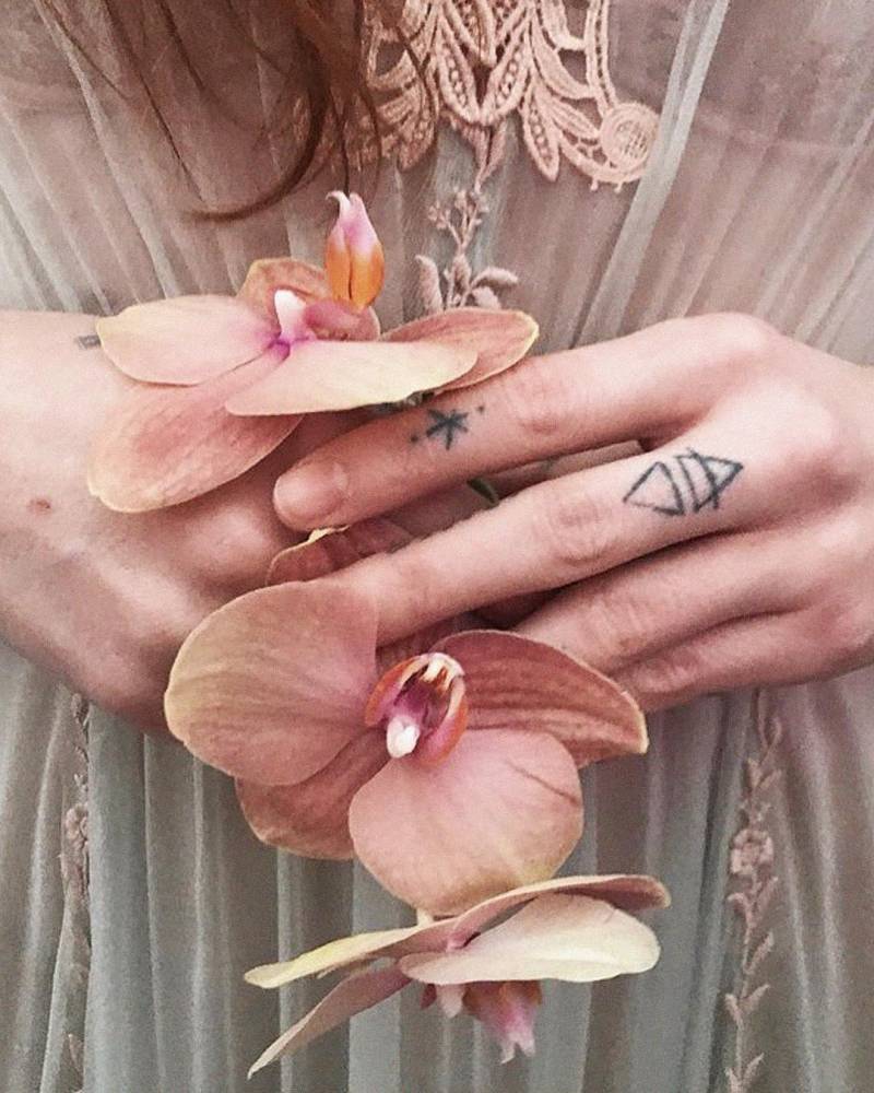 Florence Welch finger star and geometric tattoos