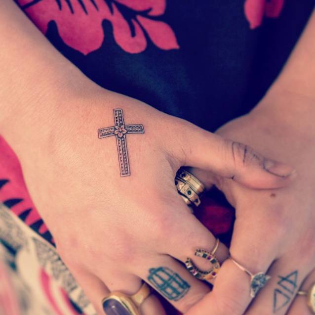Florence Welch cross and flower hand tattoo
