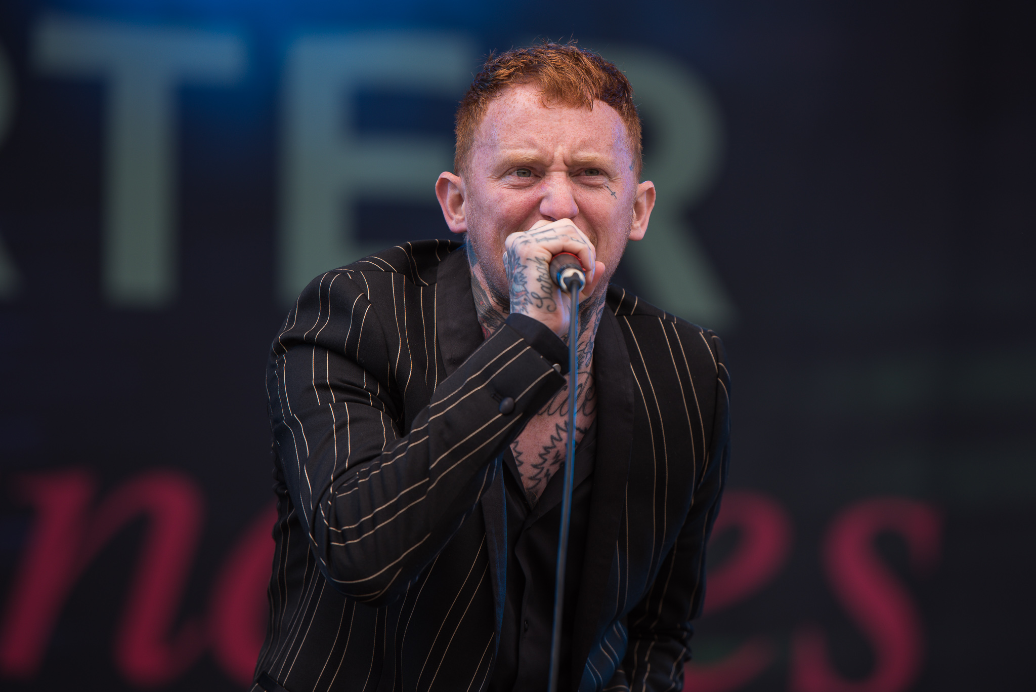 Frank Carter face and neck tattoos on stage