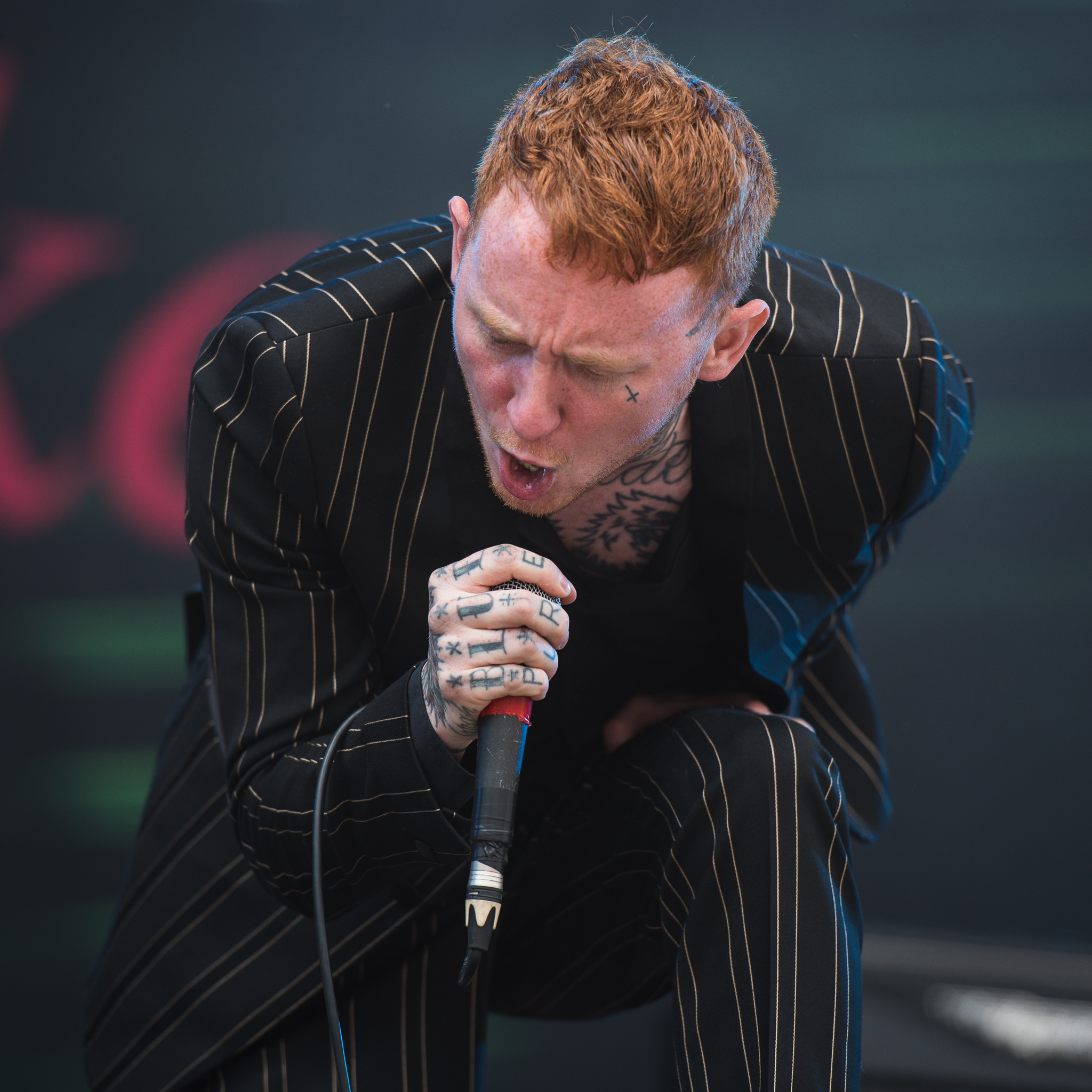 Frank Carter hand and neck tattoos while singing