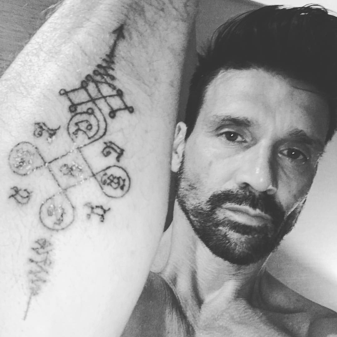 Frank Grillo tattoos: full-resolution close-up showing Thai-inspired arm symbols and lettering