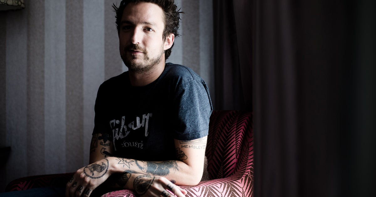 Frank Turner tattoos: Genuine tattoo photograph showing Frank Turner’s tattooed arms in an interview setting.