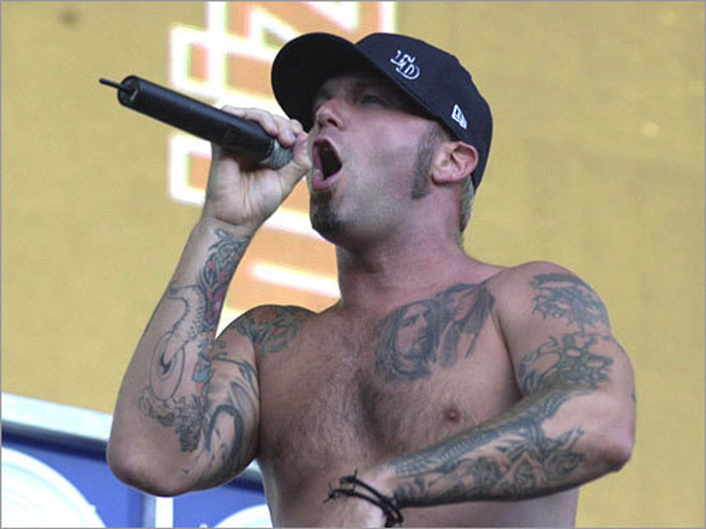 Fred Durst chest and arm tattoos