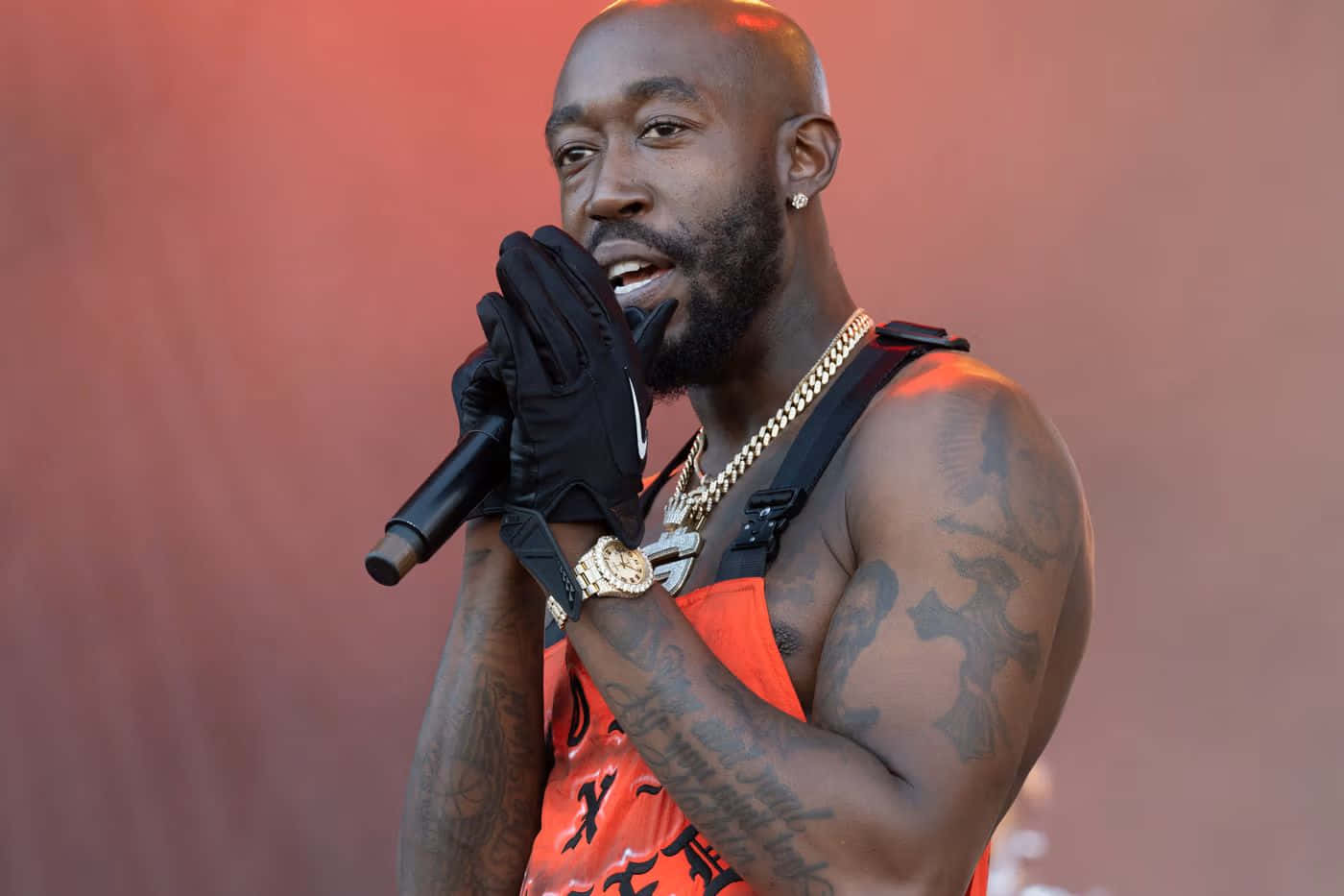 Freddie Gibbs arm tattoos with microphone