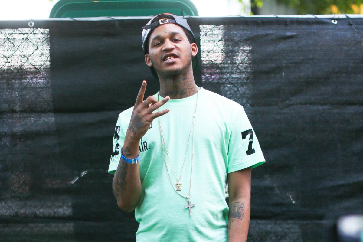 Fredo Santana tattoos: arm, wrist and neck tattoos in a live outdoor portrait