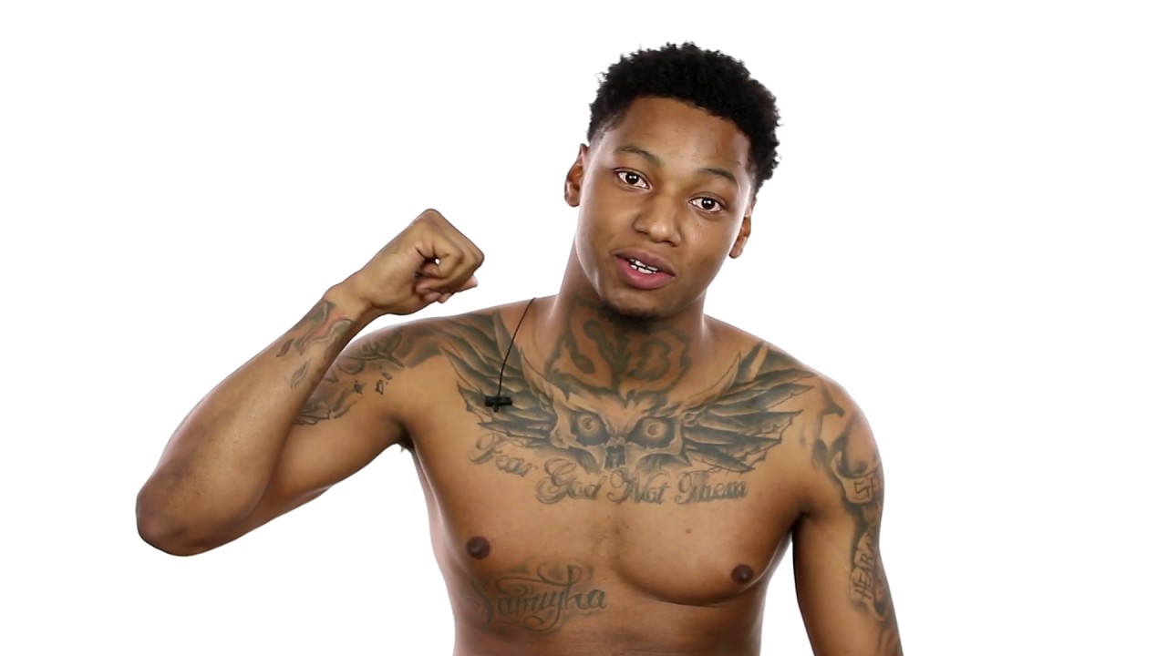 Fredo Santana tattoos: an owl chest tattoo and extensive arm ink in a bright shirtless portrait