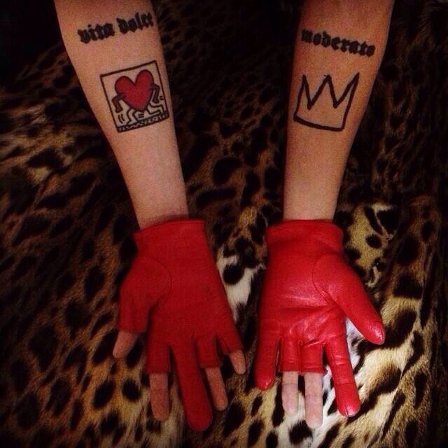 G-Dragon showing his Vita Dolce and Moderato forearm tattoos