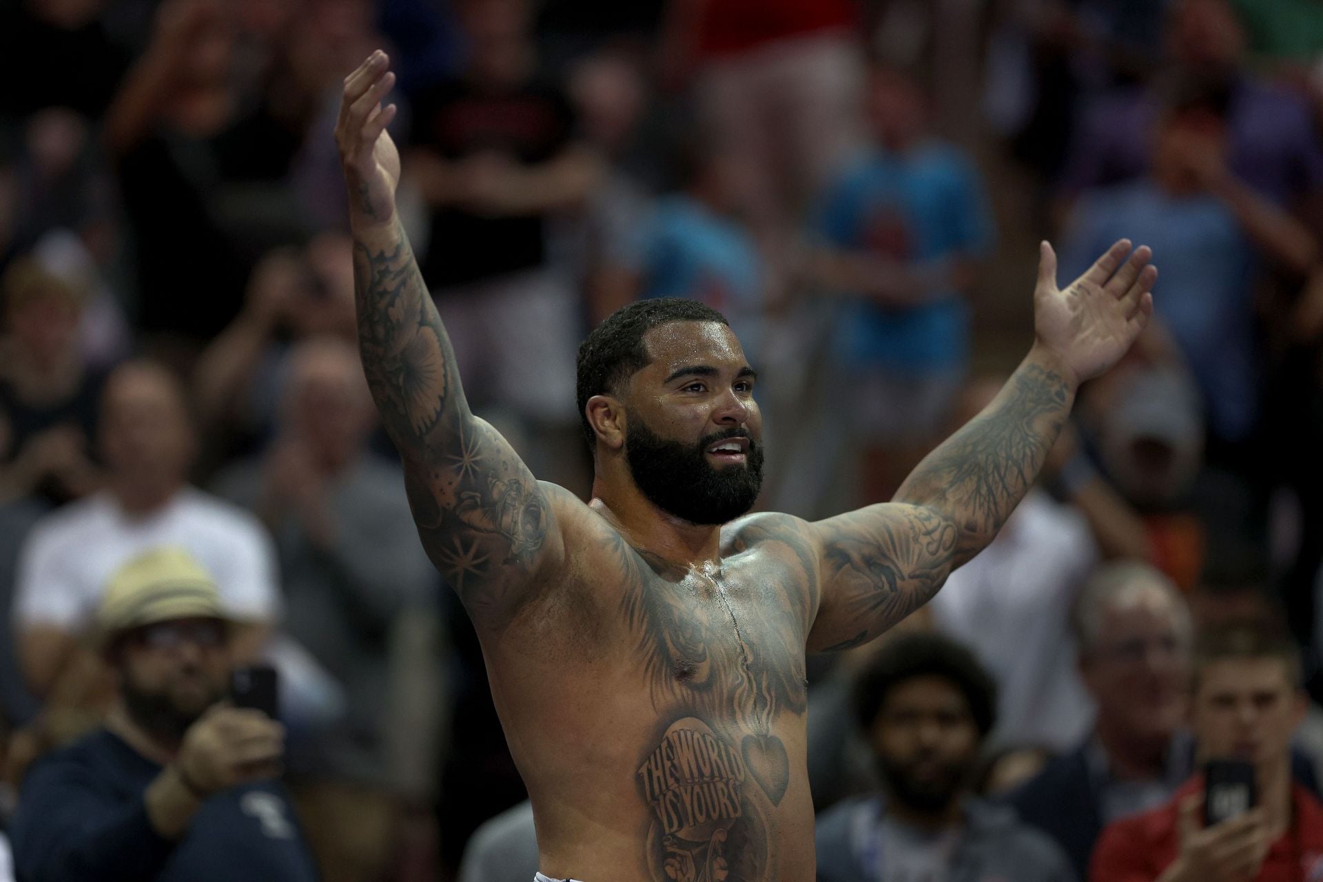 Gable Steveson shoulder lettering and forearm tattoos Gable Steveson tattoos: Close sports image showing shoulder lettering, chest script and forearm sleeve.
