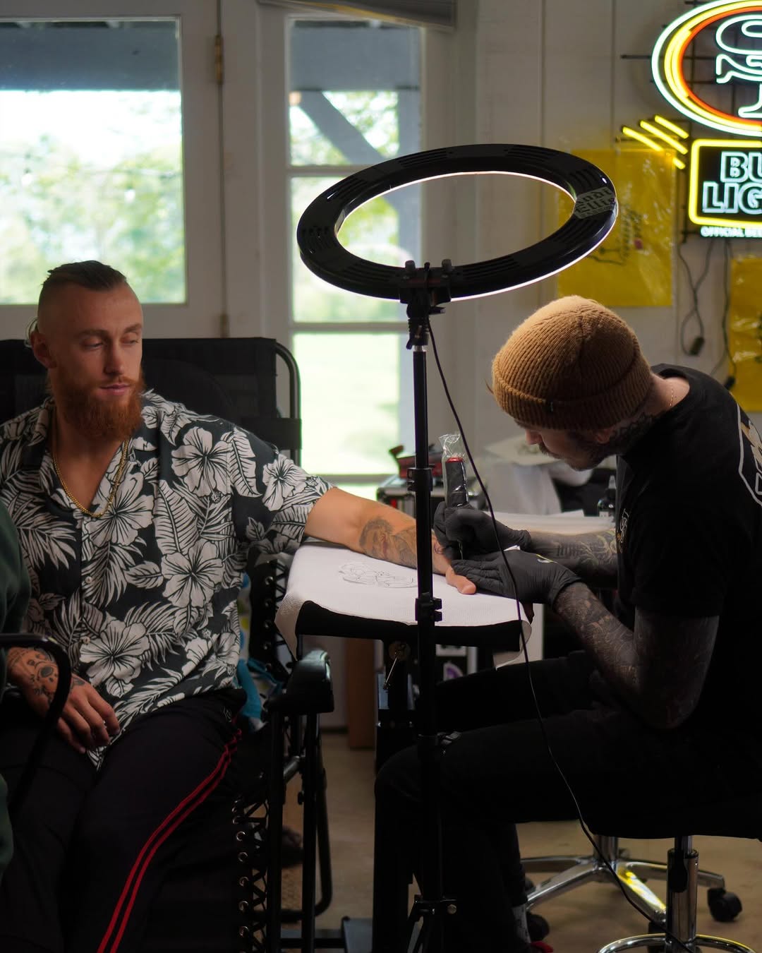 George Kittle tattoos: tattoo session photograph showing the arm work around the hero references