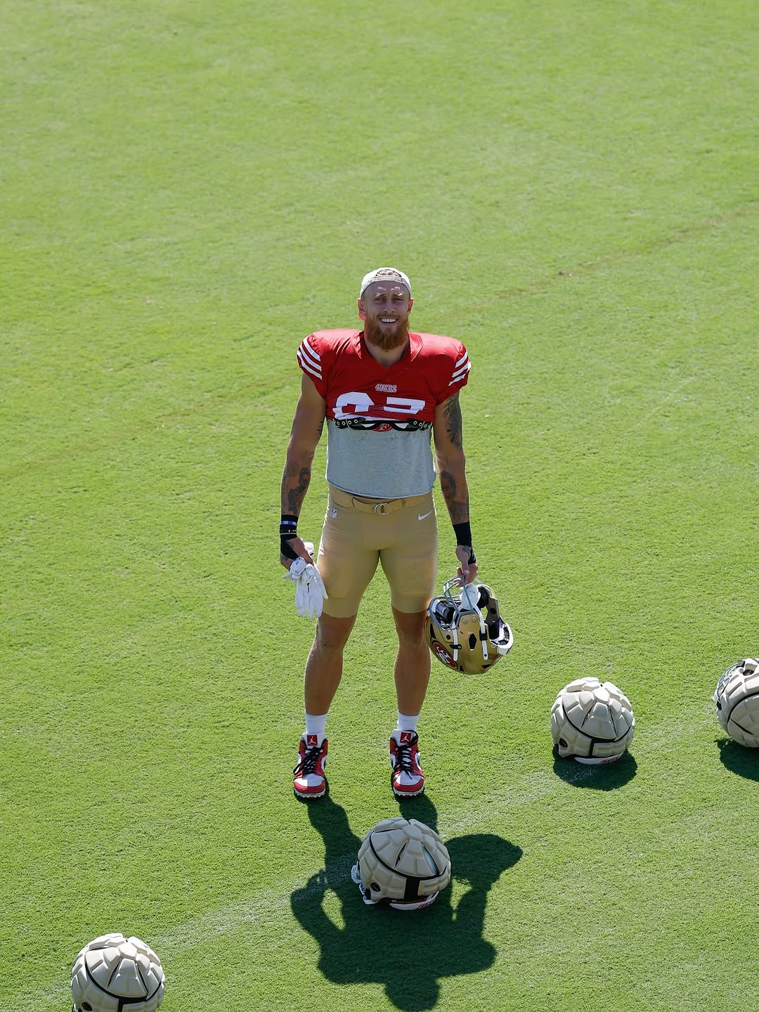 George Kittle tattoos: training photograph showing the visible forearm tattoo collection