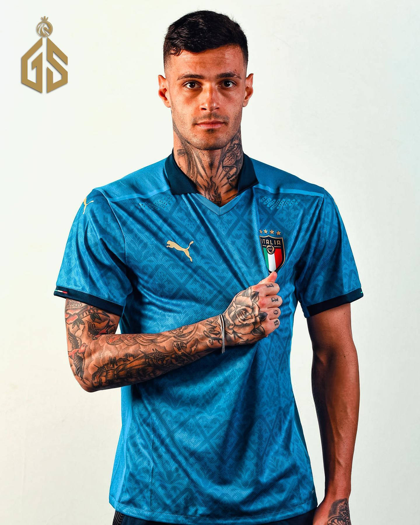 Gianluca Scamacca Layered arm and forearm coverage in a controlled portrait Gianluca Scamacca tattoos: Layered arm and forearm coverage in a controlled portrait