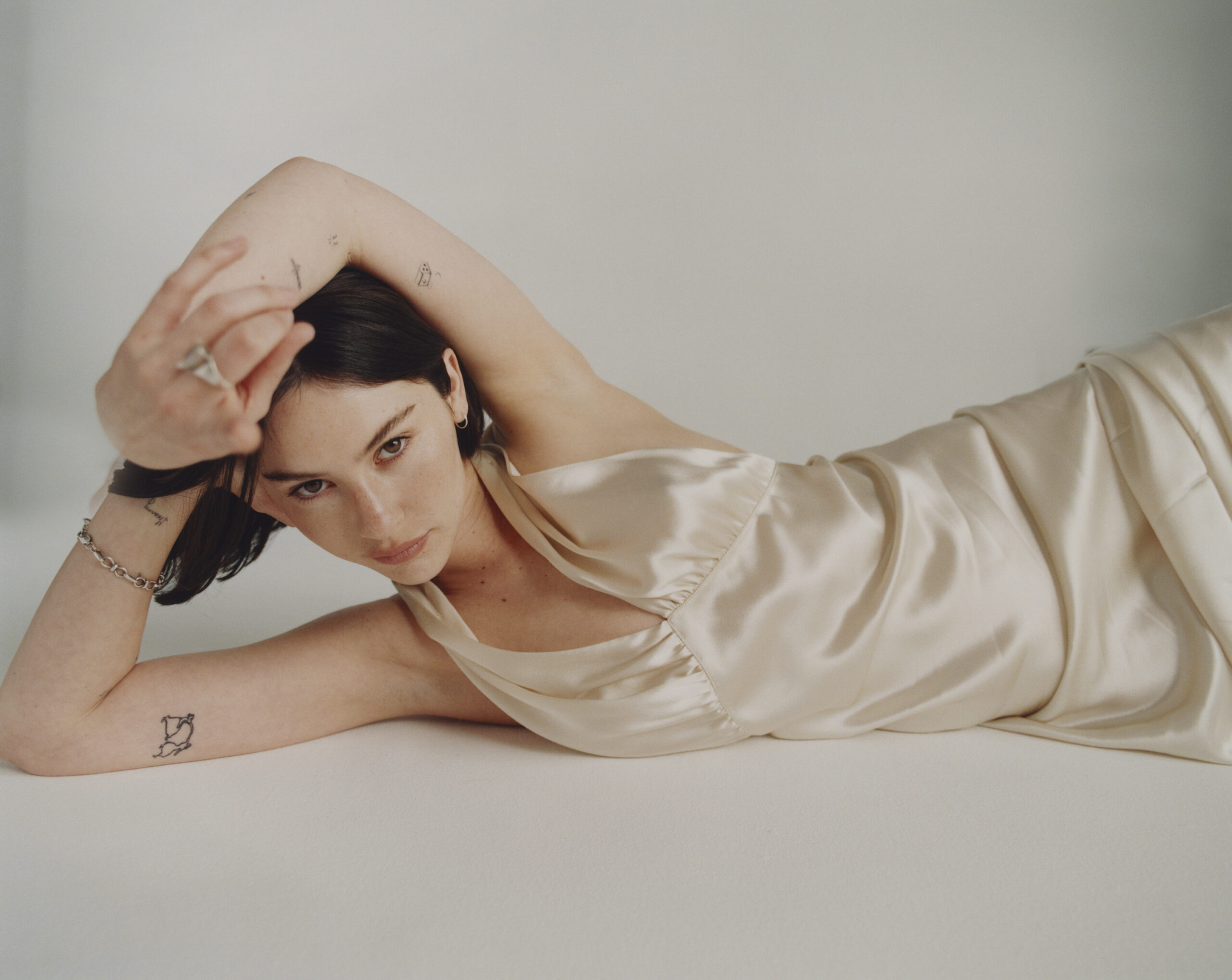 Gracie Abrams in a contextual photograph: Contextual editorial portrait; explicitly not tattoo evidence; not tattoo evidence