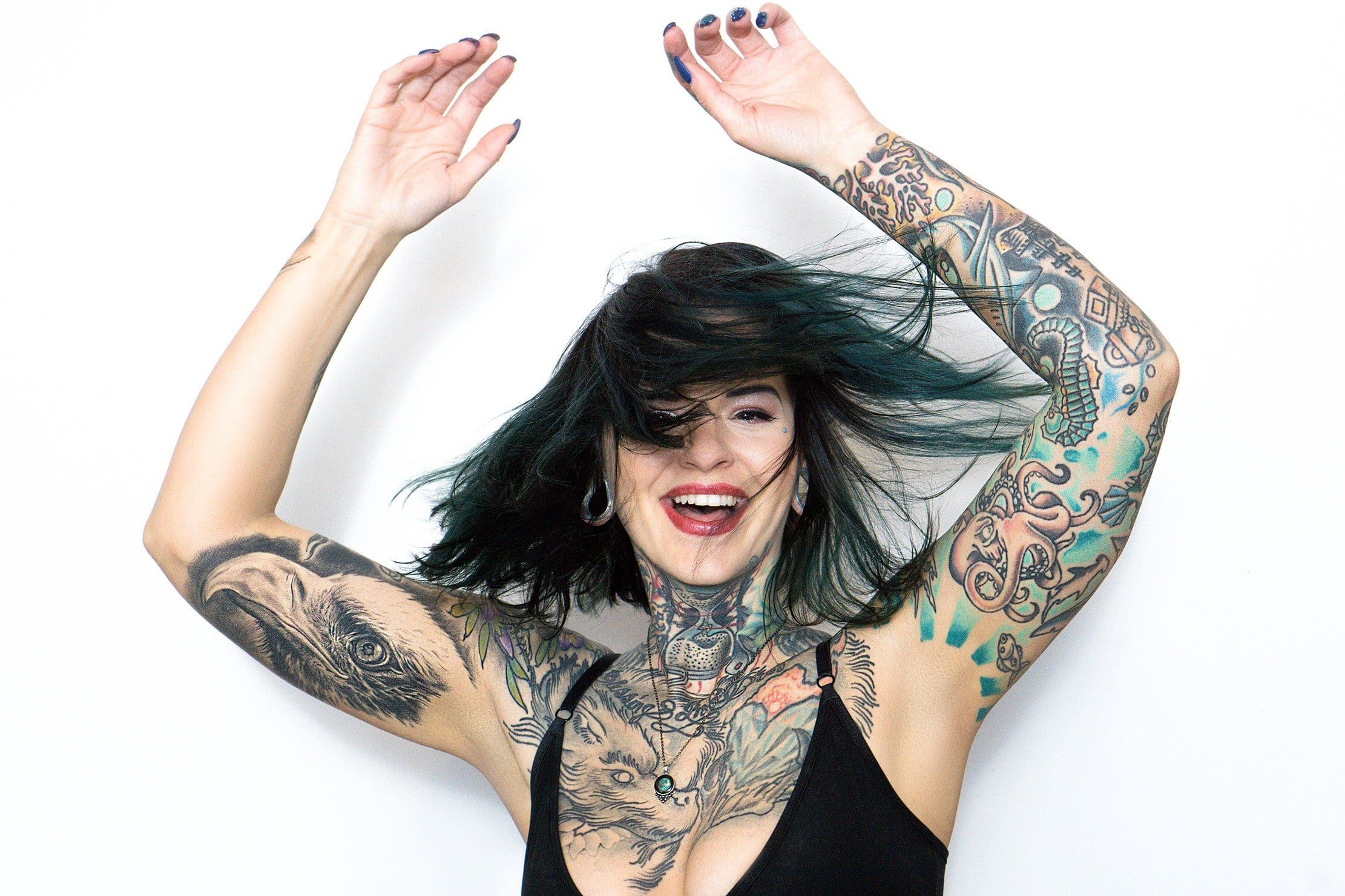 Canine head and faceted blue-green diamond across Heidi Lavon’s chest Heidi Lavon tattoos: Canine head and faceted blue-green diamond across Heidi Lavon’s chest