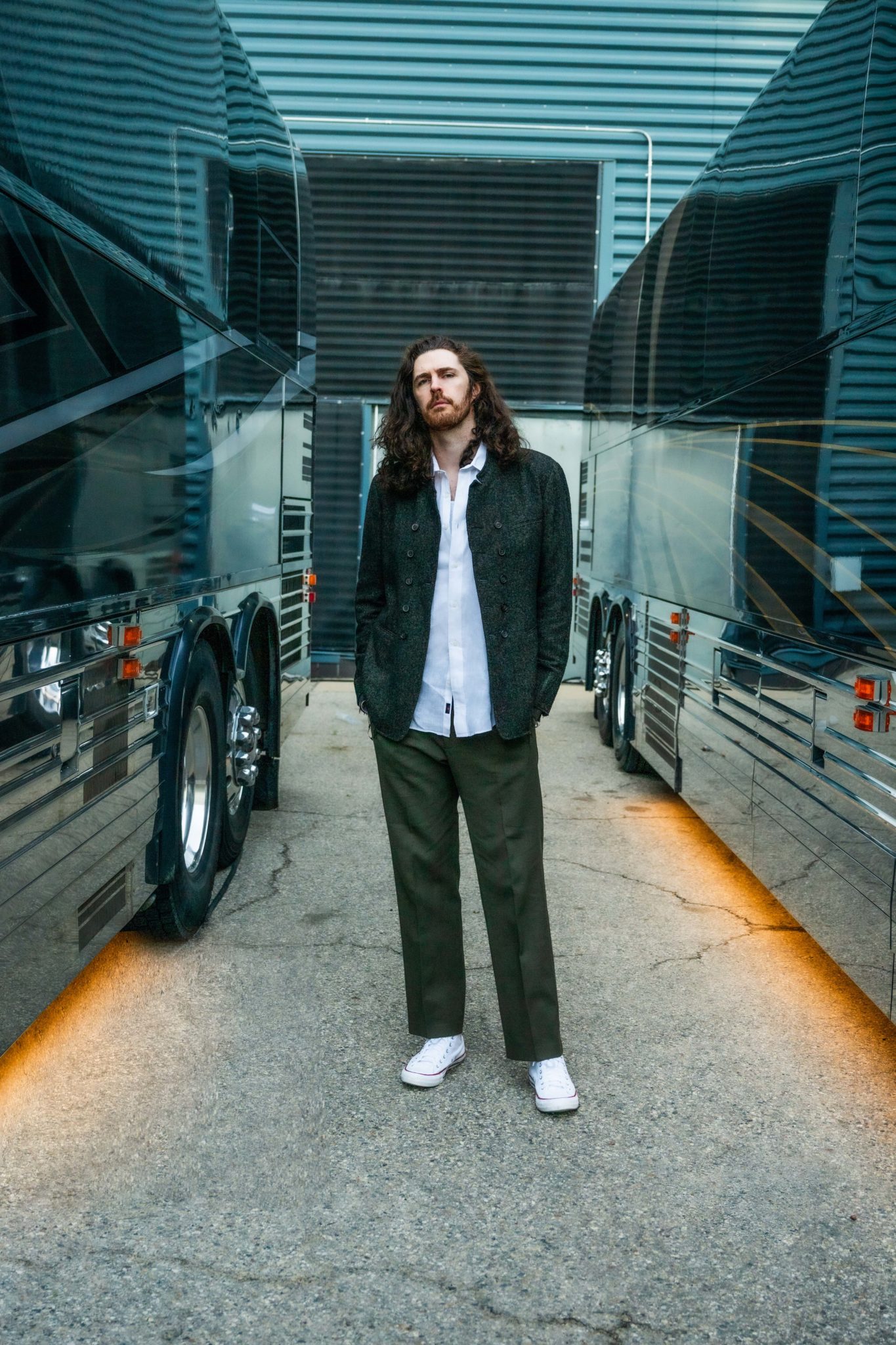 Hozier contextual portrait between tour buses Hozier tattoos: Contextual Hozier portrait between tour buses; this photograph does not show tattoo evidence