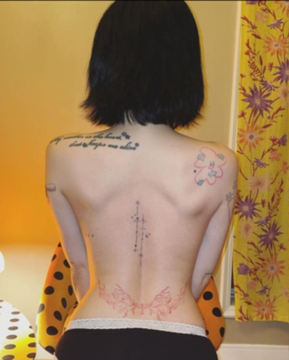 HyunA tattoos: shoulder tribute script and small back symbols