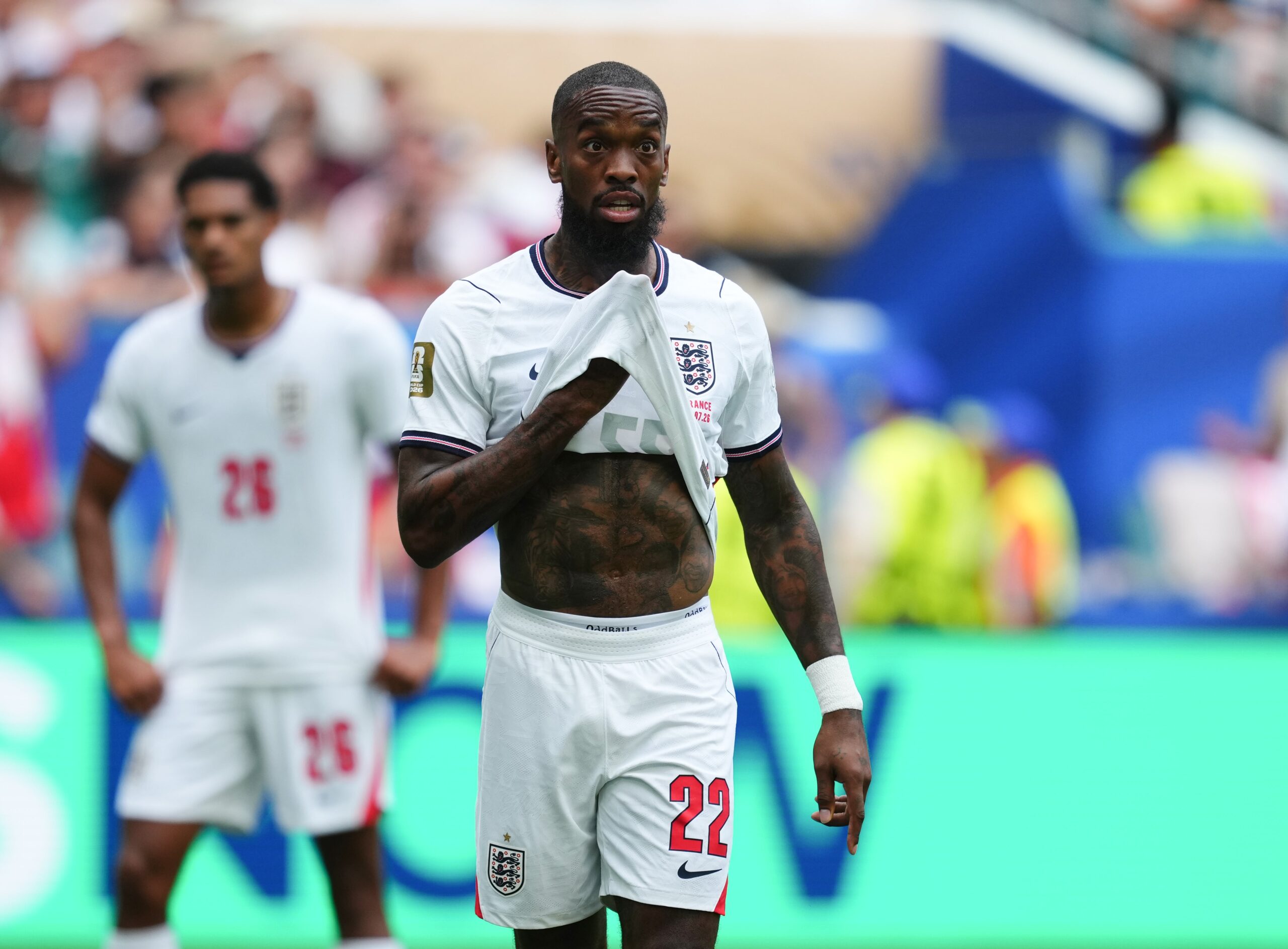 Ivan Toney tattoos: Shirt-lift photograph showing chest lettering and nearby tattoos