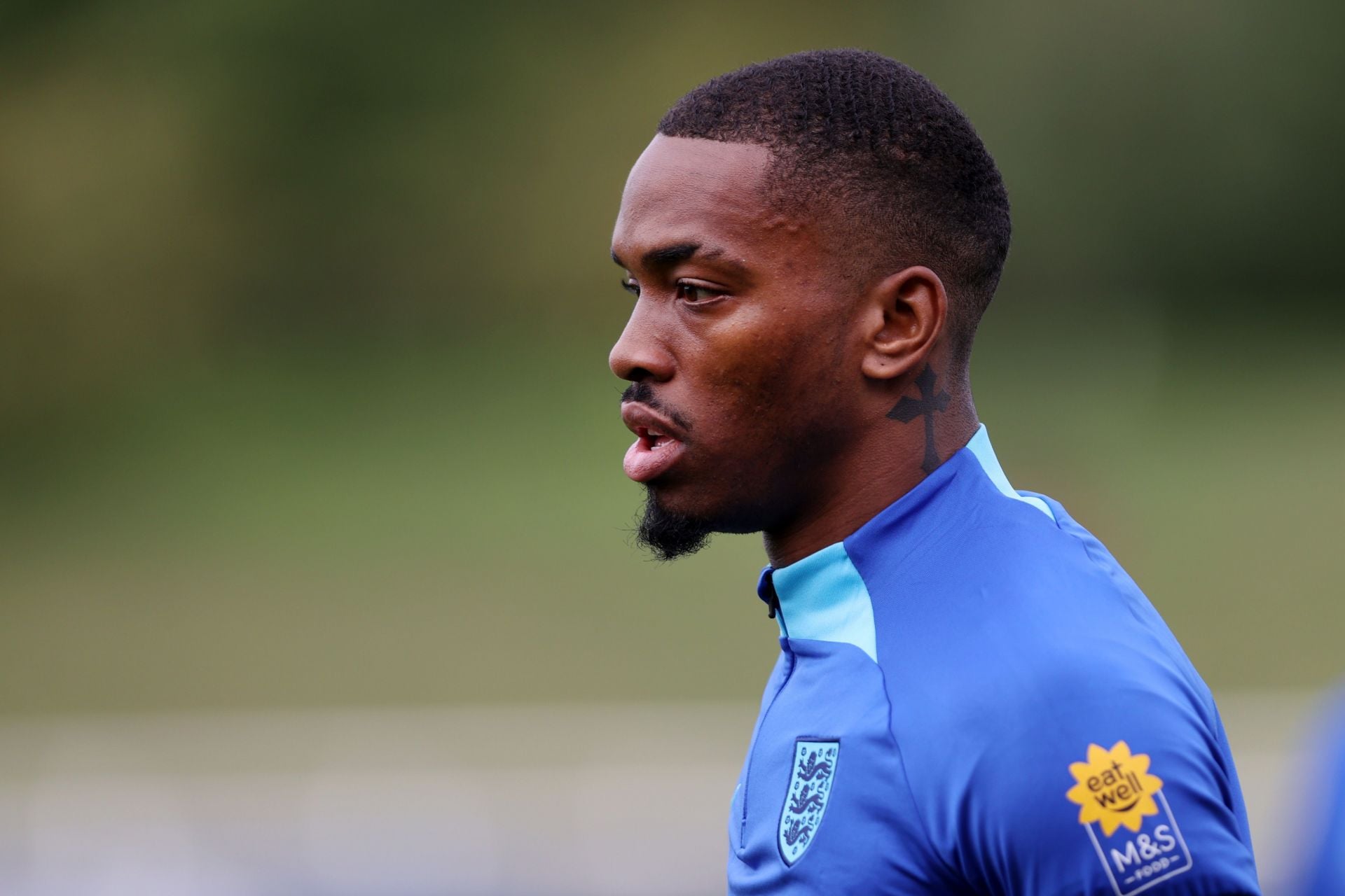 Ivan Toney tattoos: Training portrait showing the side-of-neck cross