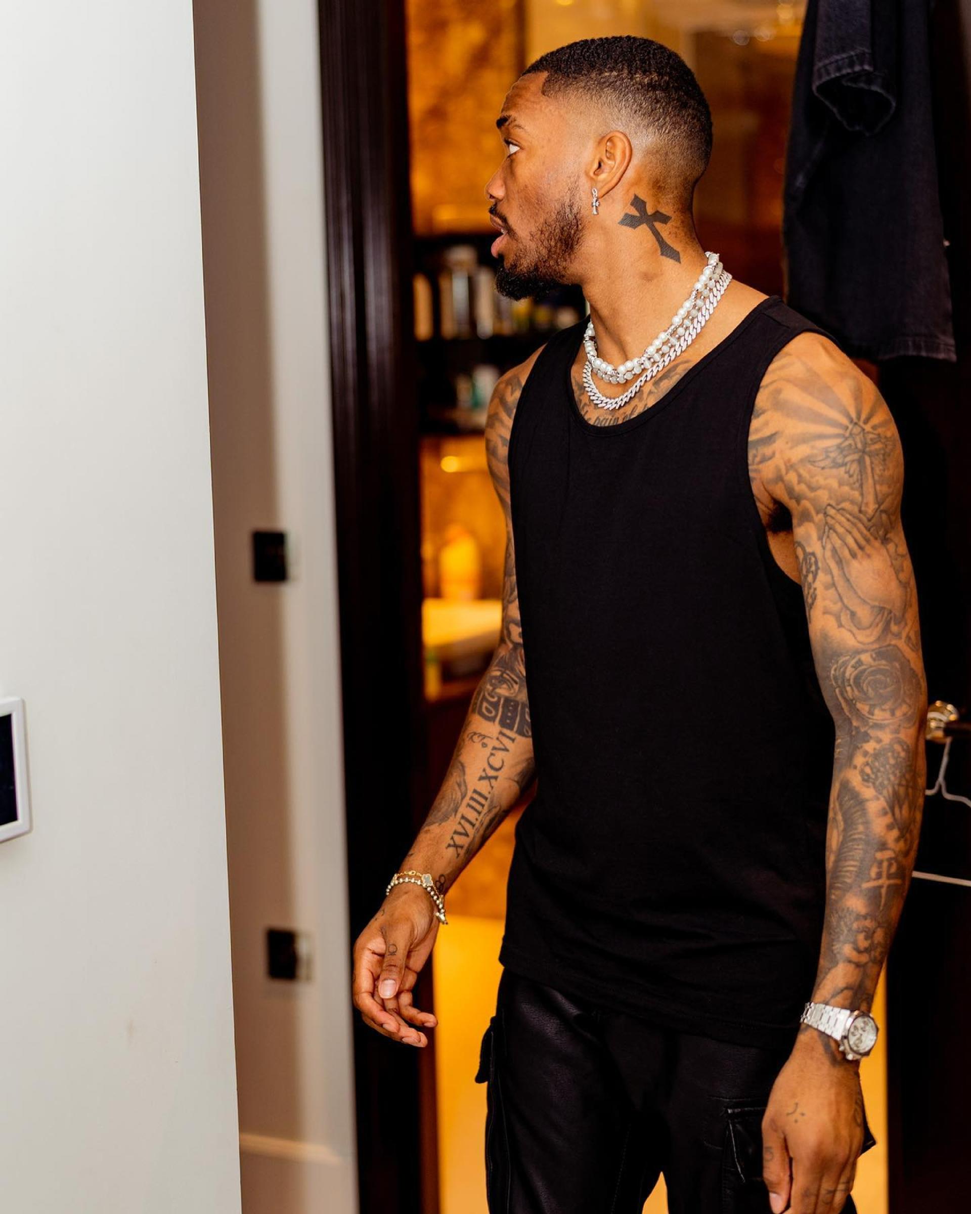 Ivan Toney tattoos: Distinct side-angle torso view accompanying the family portrait discussion